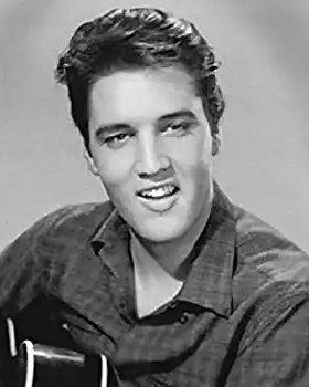 Elvis Presley holding guitar