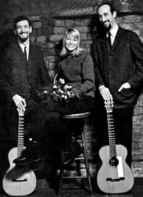 Folk singers Peter, Paul and Mary posing with guitars