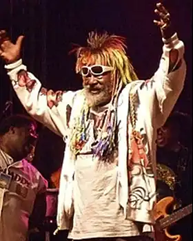 George Clinton, of Parliament standing with raised hands