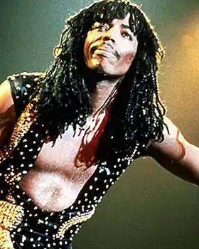 Rick James leaning and smiling