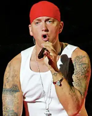 Rapper Eminem rapping in red cap and white tank top shirt