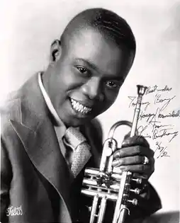 Louis Armstrong holding trumpet